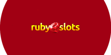 Ruby Slot Casino logo on a red circle featuring free spins.